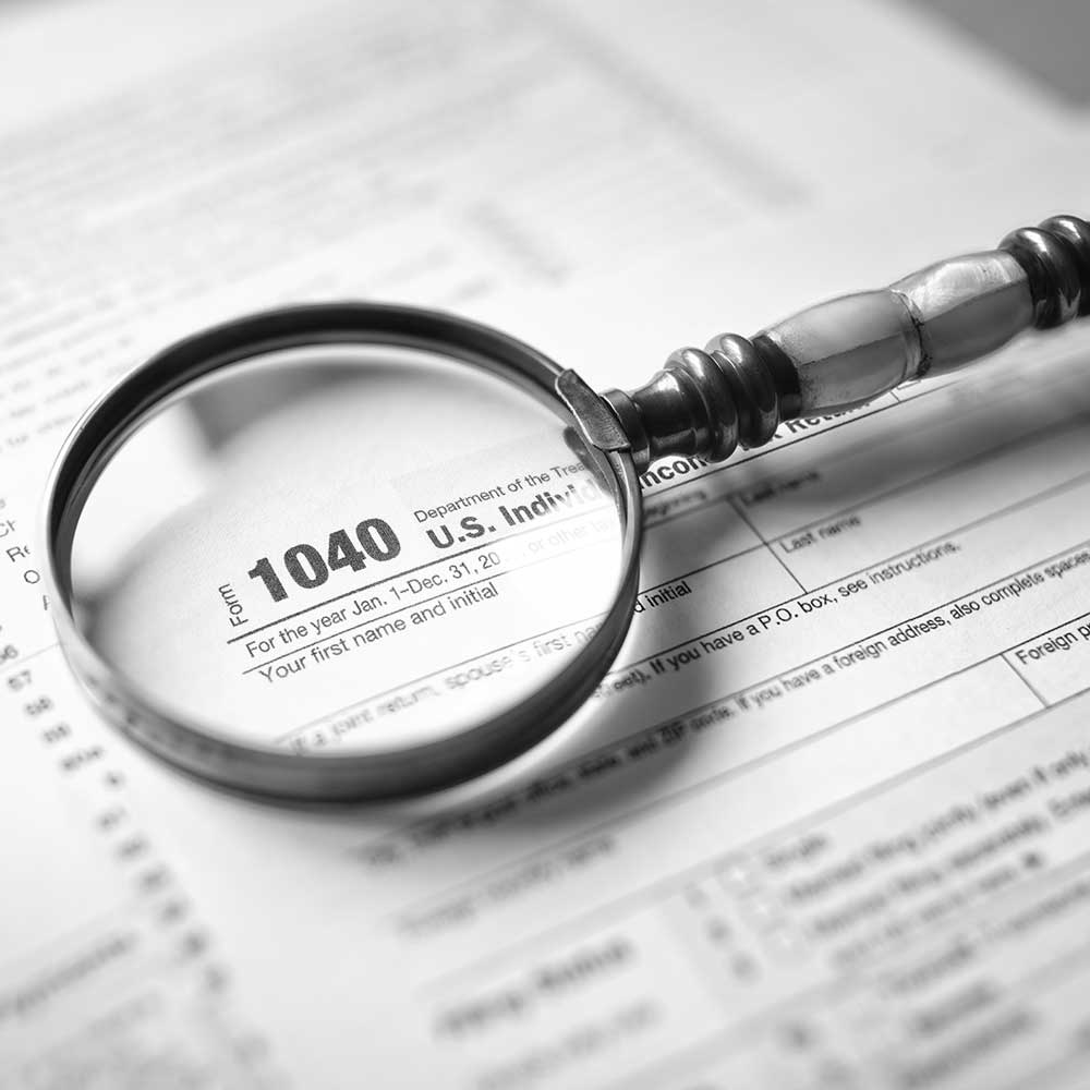 income tax form and magnifying glass